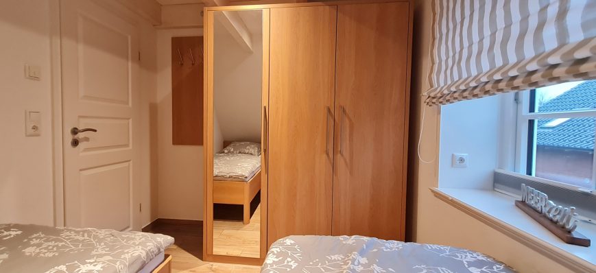 Ansicht des kleinen Schlafzimmers mit Fokus auf dem Kleiderschrank